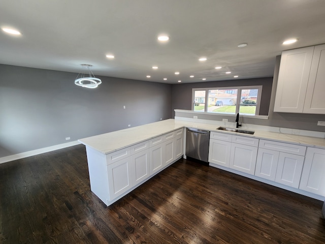 kitchen featuring stainless steel dishwasher, kitchen peninsula, sink, and white cabinets