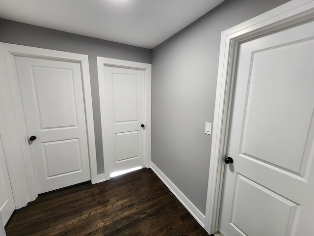 corridor with dark hardwood / wood-style flooring