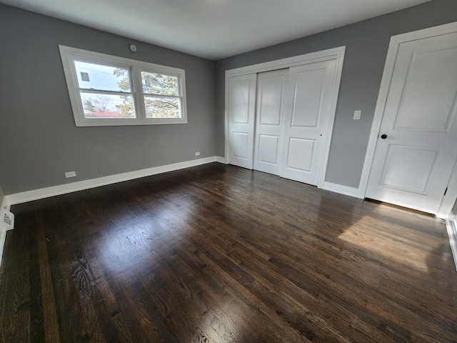 unfurnished bedroom with dark hardwood / wood-style floors