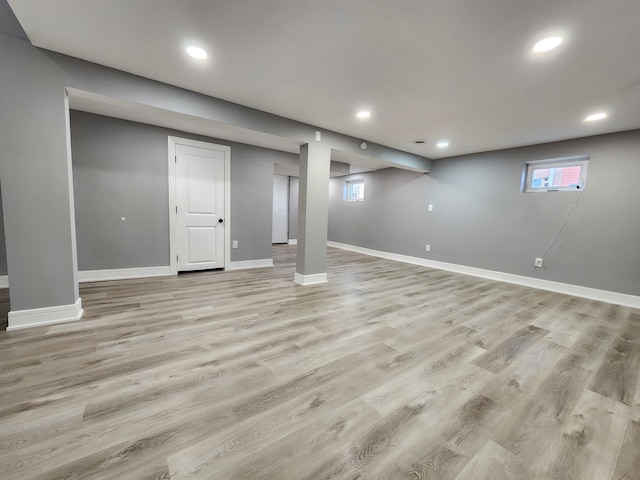 basement with light hardwood / wood-style flooring