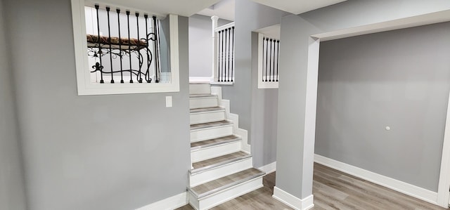 stairs featuring hardwood / wood-style floors