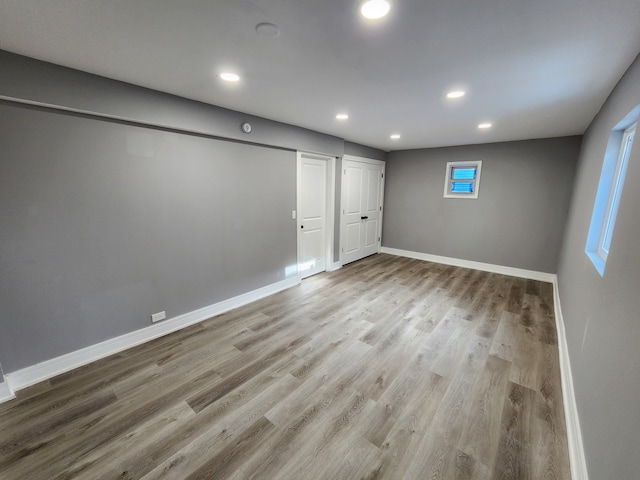 basement featuring light hardwood / wood-style flooring