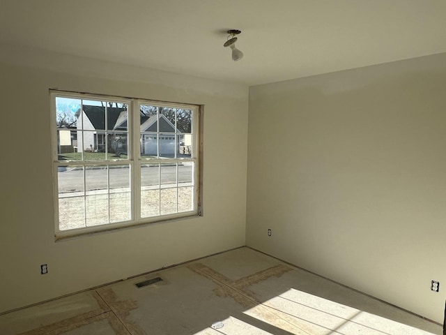 unfurnished room featuring visible vents