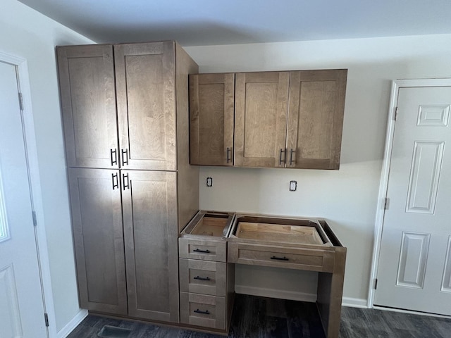 kitchen with dark wood finished floors and baseboards