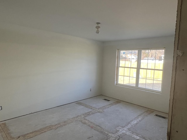 unfurnished room featuring visible vents