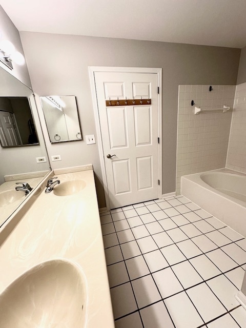 bathroom featuring tile patterned floors, vanity, and tiled shower / bath