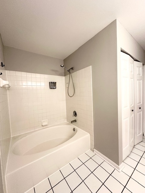 bathroom with tile patterned flooring and tiled shower / bath