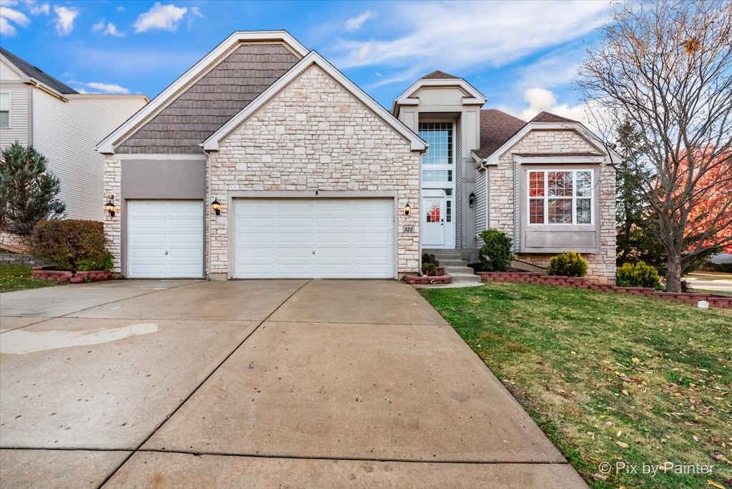 view of front of home with a garage and a front yard