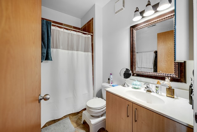 bathroom featuring toilet, vanity, and tile patterned floors