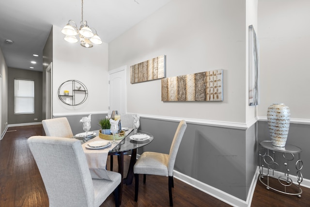 dining room featuring dark wood-type flooring and a notable chandelier