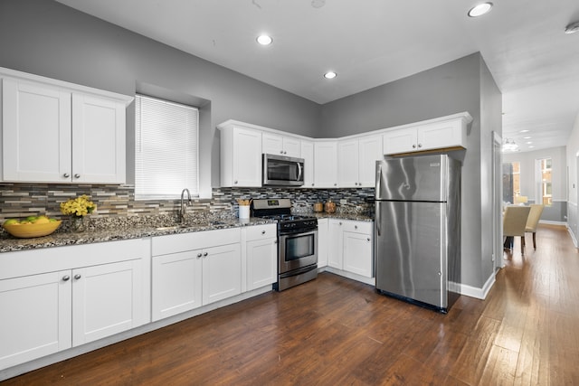 kitchen featuring dark wood-type flooring, white cabinetry, sink, and appliances with stainless steel finishes