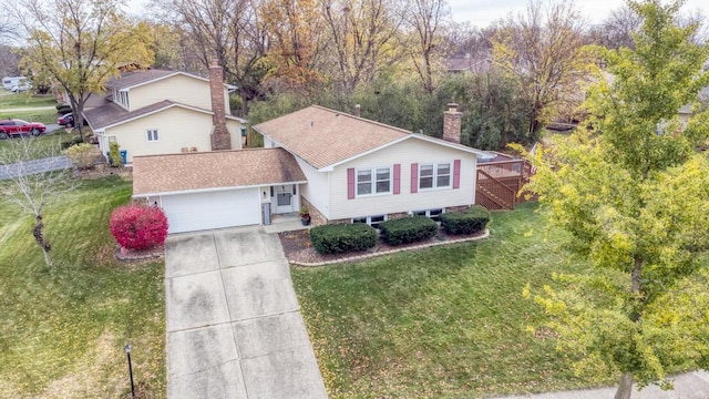 ranch-style home with a garage, a deck, and a front lawn