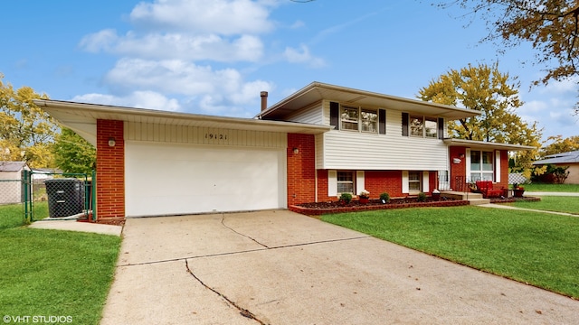 split level home with a garage and a front yard