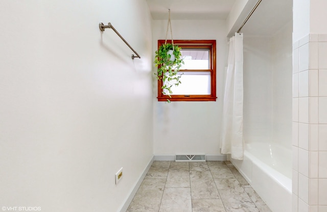 bathroom featuring shower / tub combo with curtain