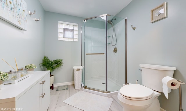 bathroom featuring toilet, tile patterned floors, and a shower with shower door