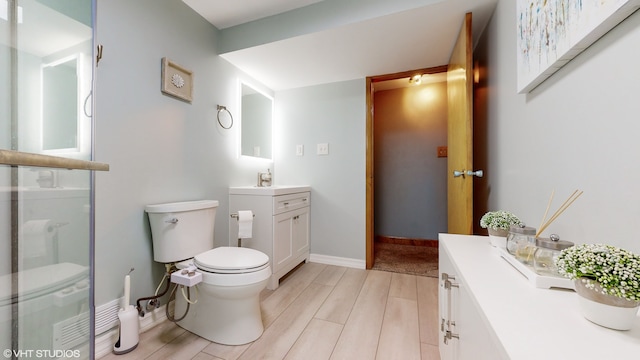 bathroom with vanity, hardwood / wood-style flooring, and toilet