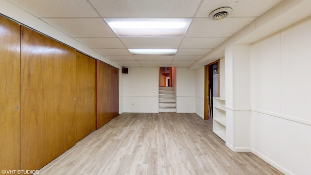 interior space featuring light hardwood / wood-style flooring and a drop ceiling