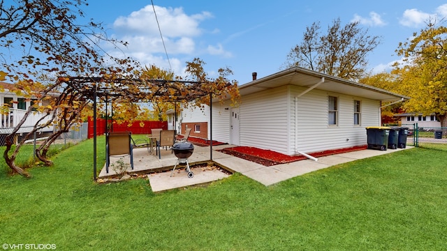 back of property featuring a pergola, a lawn, and a patio