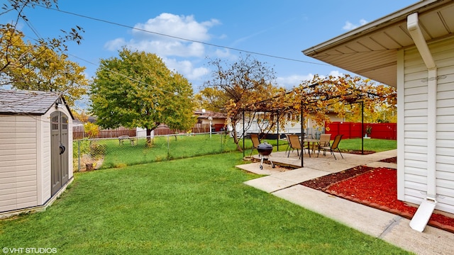 view of yard with a storage unit and a patio