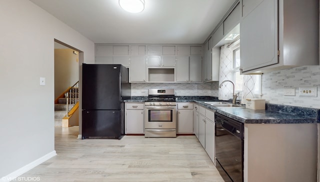 kitchen featuring sink, black appliances, tasteful backsplash, light hardwood / wood-style flooring, and gray cabinetry