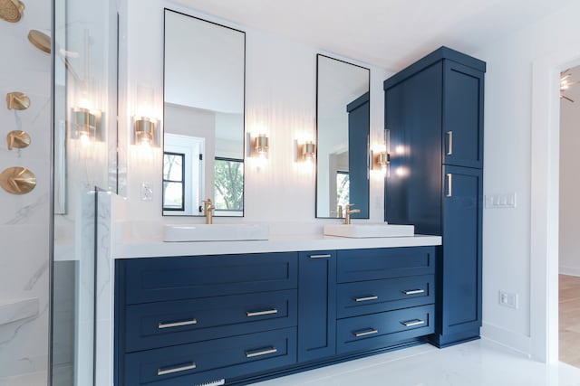 bathroom featuring a shower with door and vanity