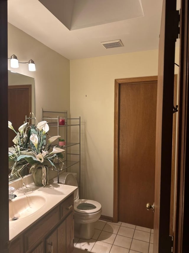 bathroom featuring vanity, toilet, and tile patterned flooring