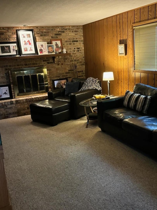 carpeted living room featuring brick wall, wooden walls, a brick fireplace, and a textured ceiling