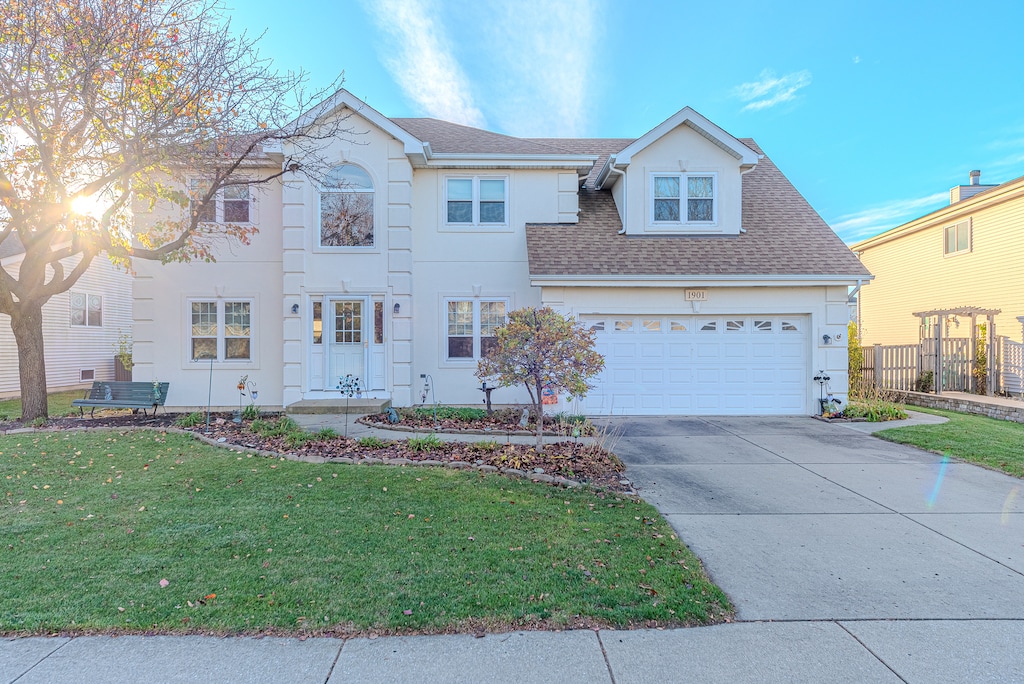 view of front of property with a garage and a front lawn