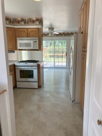 kitchen featuring white appliances and ceiling fan