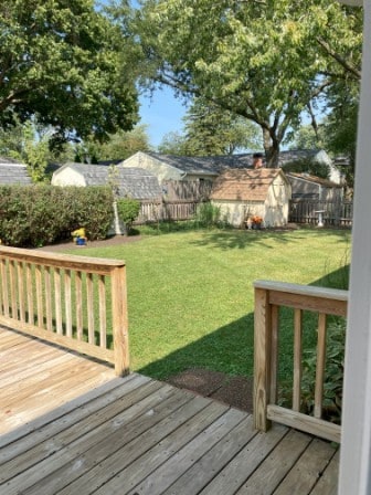 view of yard featuring a storage shed and a wooden deck