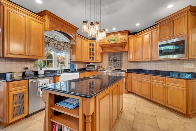 kitchen with a kitchen island, dark stone countertops, stainless steel appliances, open shelves, and a sink