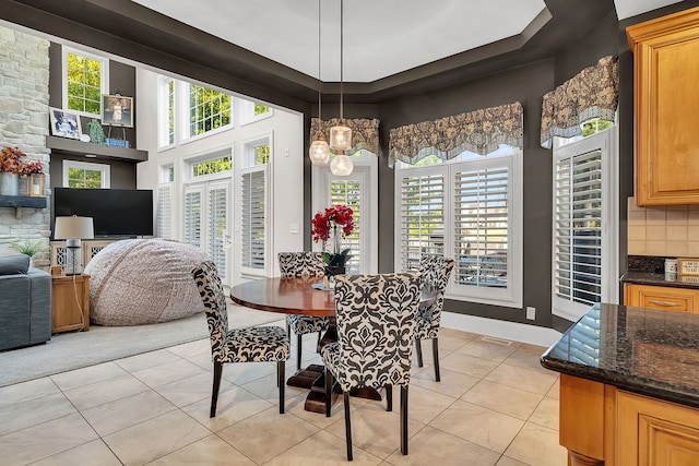 dining room with wine cooler, a wealth of natural light, baseboards, and light tile patterned floors