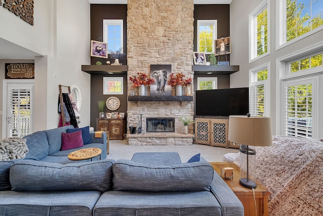living area featuring a fireplace and a high ceiling