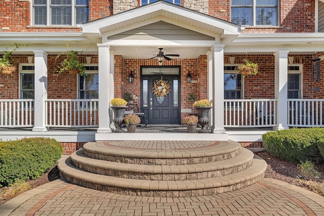 entrance to property featuring covered porch and brick siding