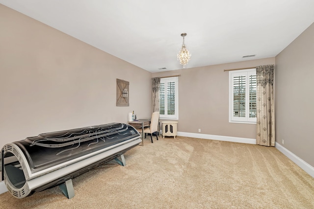 sitting room with plenty of natural light, carpet flooring, visible vents, and baseboards