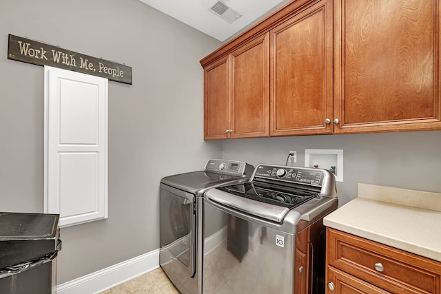 laundry area with cabinet space, baseboards, visible vents, independent washer and dryer, and light tile patterned flooring