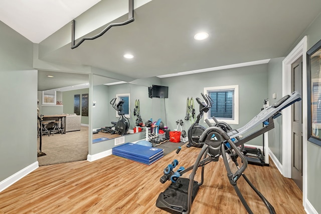 exercise area with recessed lighting, baseboards, and wood finished floors