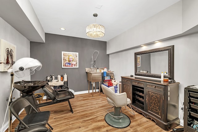 interior space with light wood-type flooring, baseboards, a notable chandelier, and recessed lighting