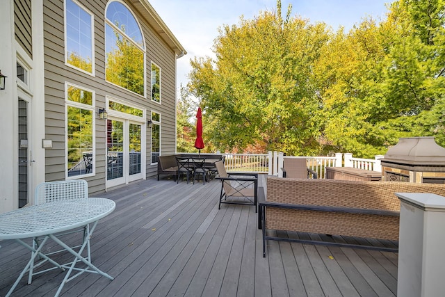 wooden terrace with outdoor dining space