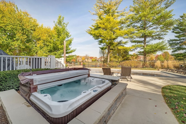 view of patio with fence and a covered hot tub