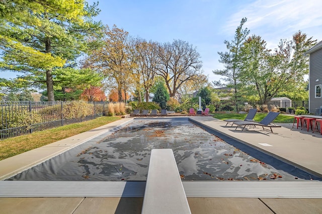view of pool with a patio area and fence