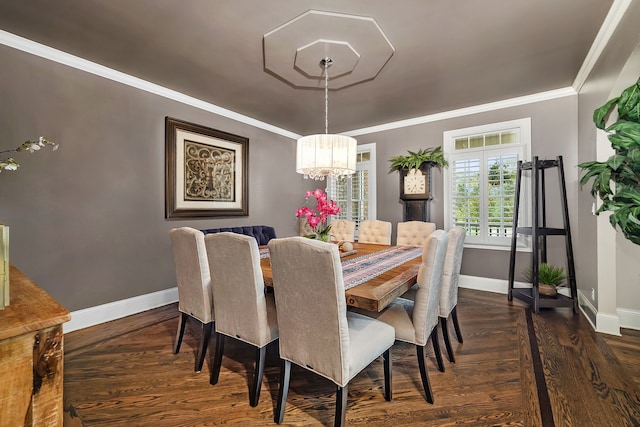 dining room with baseboards, ornamental molding, and wood finished floors