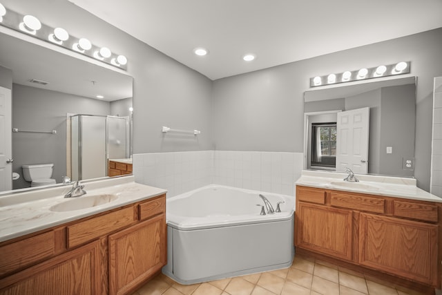 full bathroom featuring independent shower and bath, tile patterned floors, vanity, and toilet