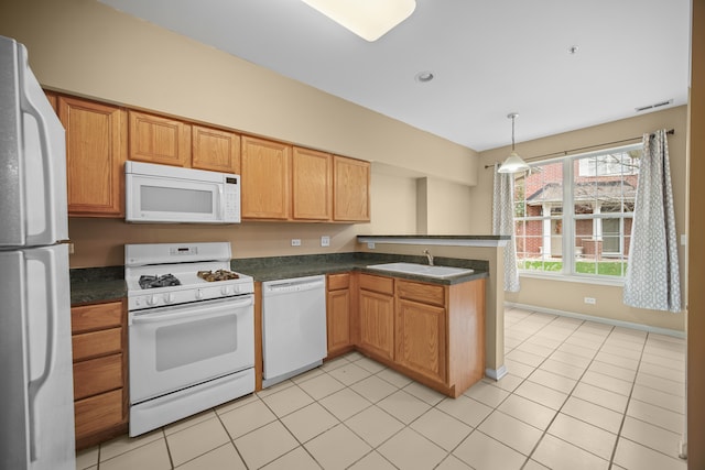 kitchen with kitchen peninsula, sink, light tile patterned flooring, pendant lighting, and white appliances