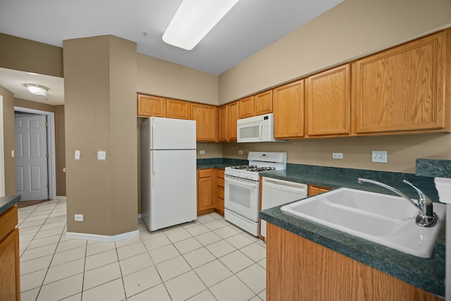 kitchen with white appliances, sink, and light tile patterned flooring