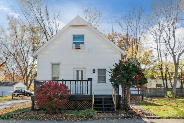 rear view of property featuring a wooden deck