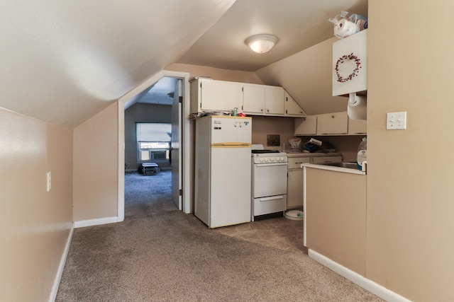 kitchen featuring white cabinets, white appliances, dark colored carpet, and vaulted ceiling