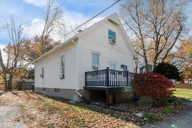 view of side of property featuring a wooden deck and cooling unit