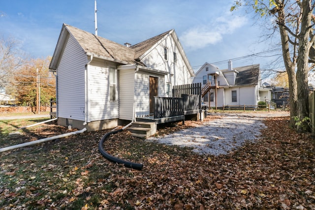 rear view of house featuring a deck