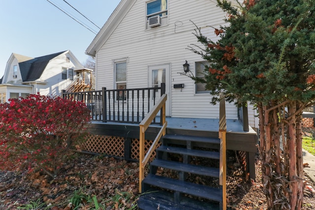 back of house featuring a deck and cooling unit